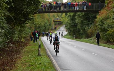 Radfahrer bei einem Wettkampf auf der Brücke Zuschauer